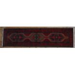A HAND KNOTTED PERSIAN HAMADAN RUNNER, 20TH CENTURY, three central medallions within a deep