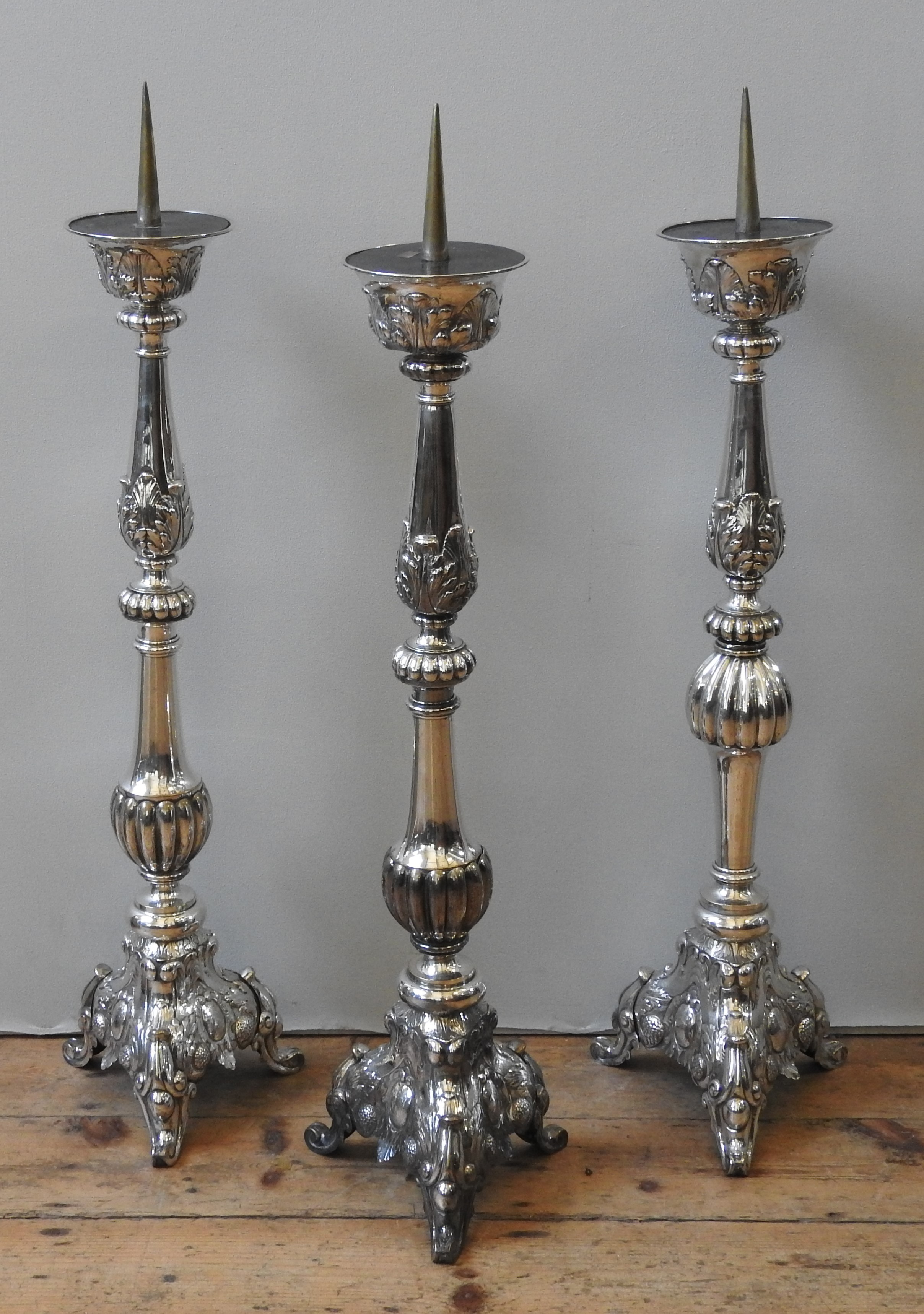 A GROUP OF THREE SILVER PLATED ALTAR CANDLE STANDS, 19TH CENTURY, knopped fluted baluster columns