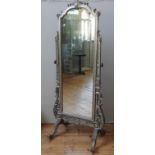 A SILVERED CHEVAL MIRROR, EARLY 20TH CENTURY, the arch top adjustable plate mounted on a rococo