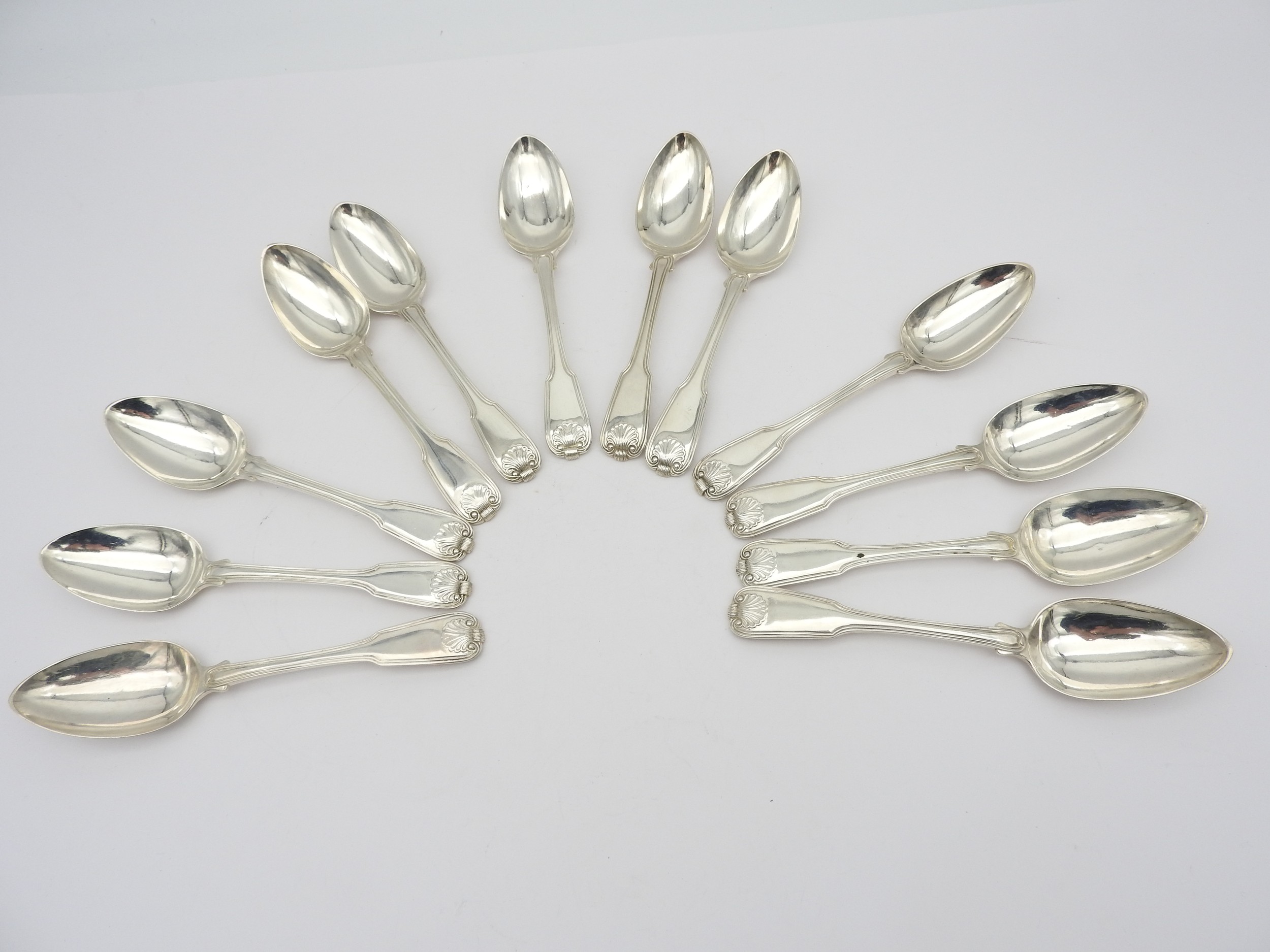 A SET OF TWELVE GEORGE III SILVER DESSERT SPOONS, threaded fiddle pattern with shell decoration,