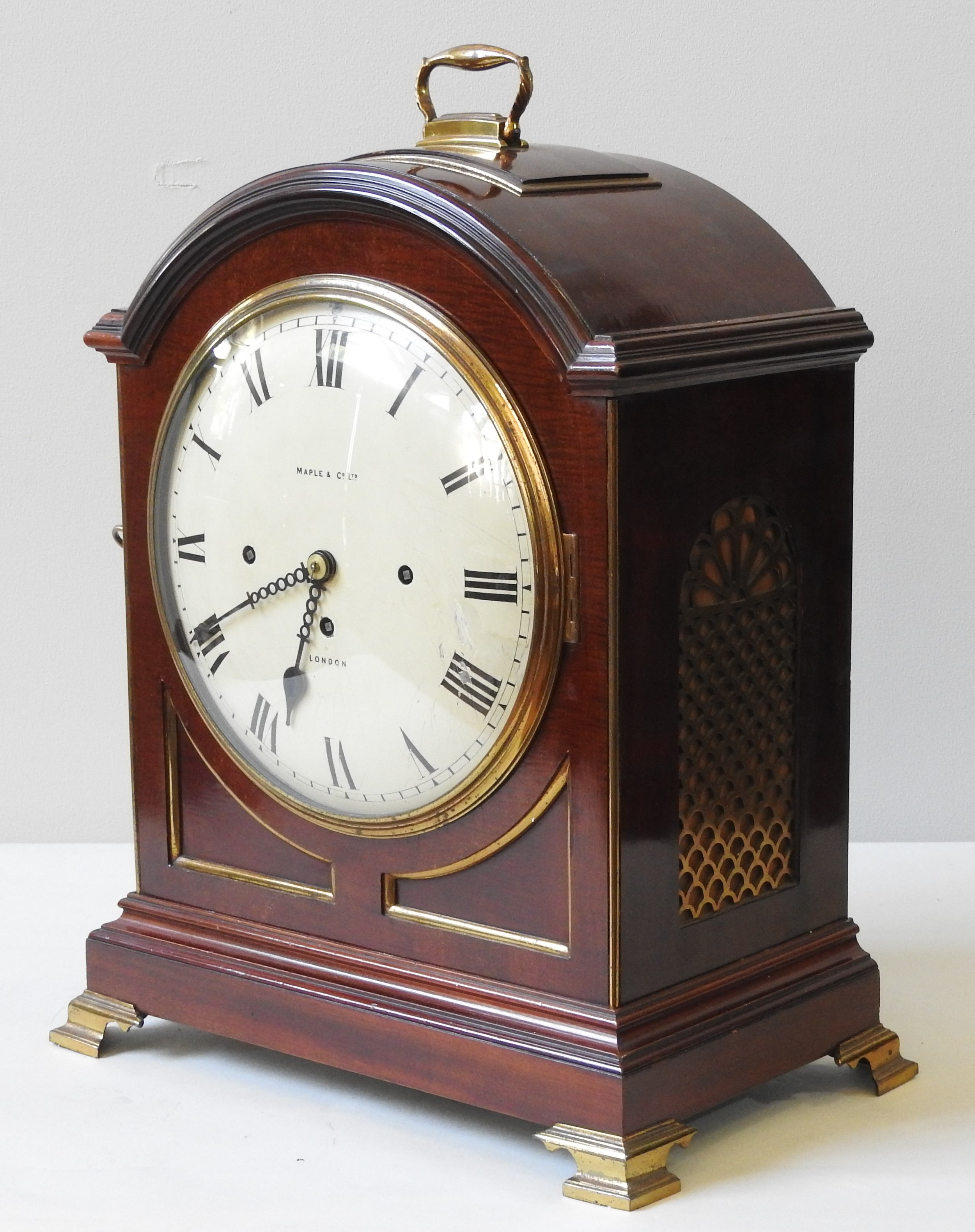 A REGENCY STYLE MAHOGANY BRACKET CLOCK, EARLY 20TH CENTURY, retailed by Maple & Co. Ltd, arched