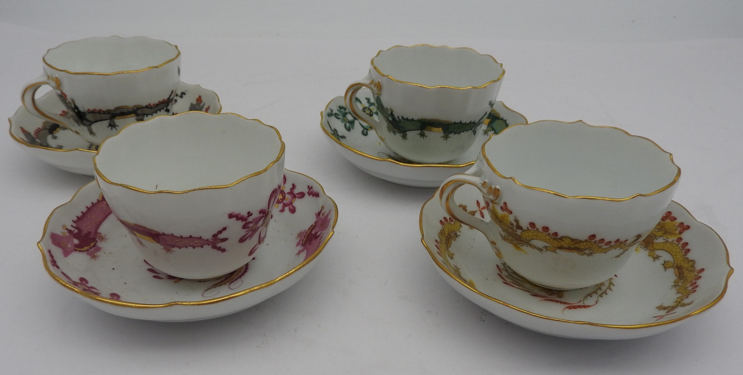 FOUR LATE 19TH CENTURY MEISSEN DEMATISSE CUPS & SAUCERS, decorated with Chinese dragons and