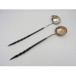 TWO GEORGE III SILVER TODDY LADLES, both with twist handles, one inset with a George II silver