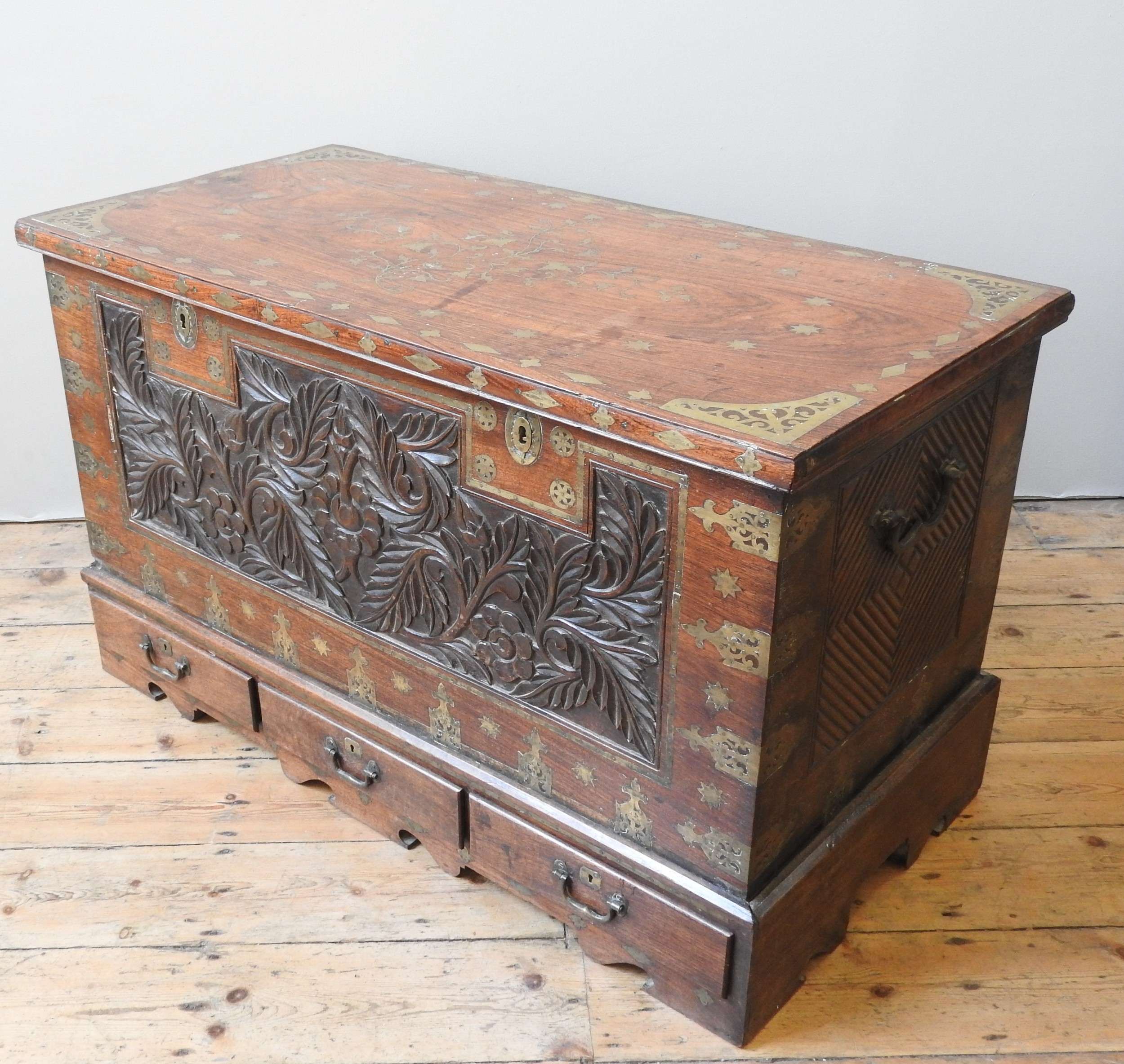 A 19TH CENTURY ZANZIBAR STYLE ROSEWOOD CHEST, profuse brass inlaid decoration throughout, the hinged