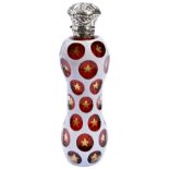 A BOHEMIAN WHITE AND RUBY CASED GLASS SCENT BOTTLE, cut with oval roundels pointed with gold