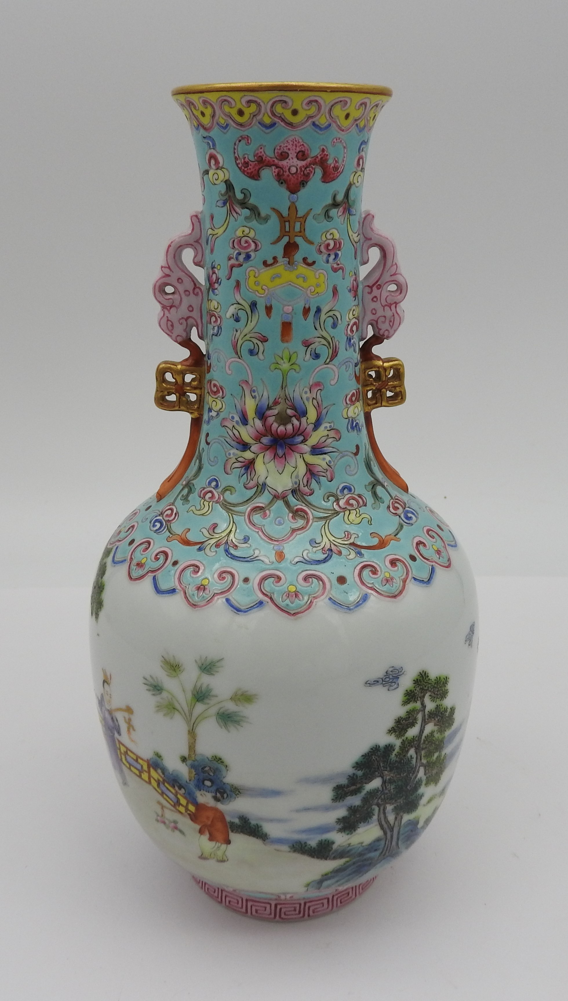 A CHINESE FAMILLE ROSE BOTTLE VASE, Republic Period (1912-1949), the neck decorated in the typical