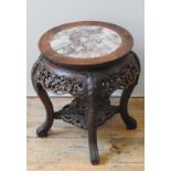 A CHINESE CARVED HARDWOOD STAND, QING DYNASTY, 19TH CENTURY, the circular top inset with marble