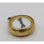 AN 18 CARAT GOLD COMPASS FOB, circular form, the reverse with inset carnelian panel 2.5 cm diam,
