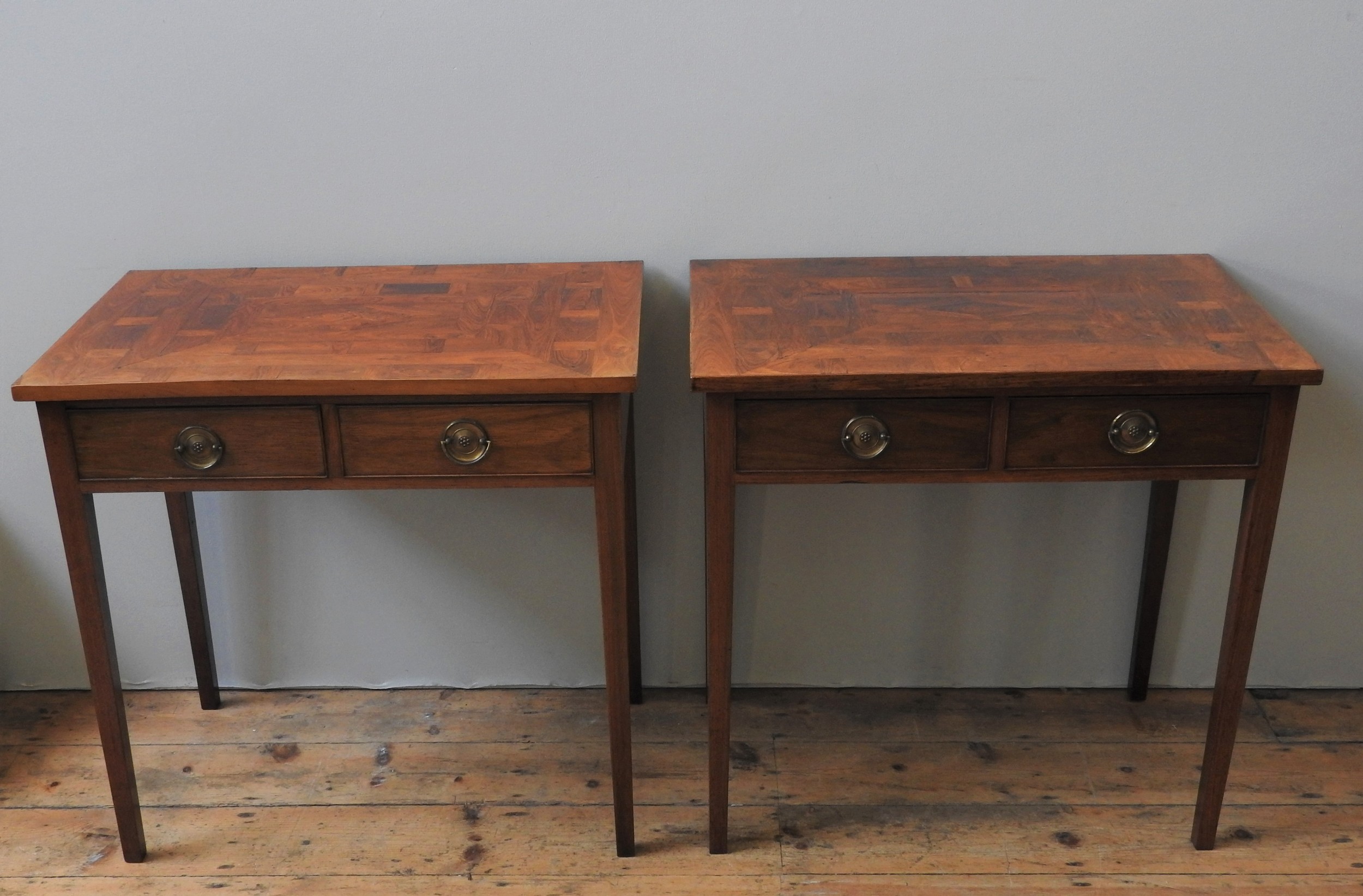 A PAIR OF PADOUK SIDE TABLES, CIRCA 1810, the parquertry veneer rectangular tops above two frieze