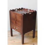 A GEORGE III MAHOGANY NIGHT COMMODE, 1780, a pierced scroll edge tray top above two cupboard