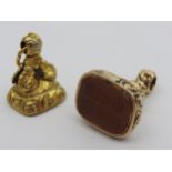 AN ORNATE GOLD INTAGLIO FOB SEAL AND A GOLD FILLED CORNELIAN FOB, the large fancy gold fob with