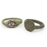 TWO ROMAN INTAGLIO RINGS, one with an incised hardstone depicting a mythical creature, the other