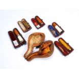 A CASED MEERSCHAUM AND AMBER CHEROOT HOLDER, four others and a pipe. PROVENANCE: The Dr. Christopher