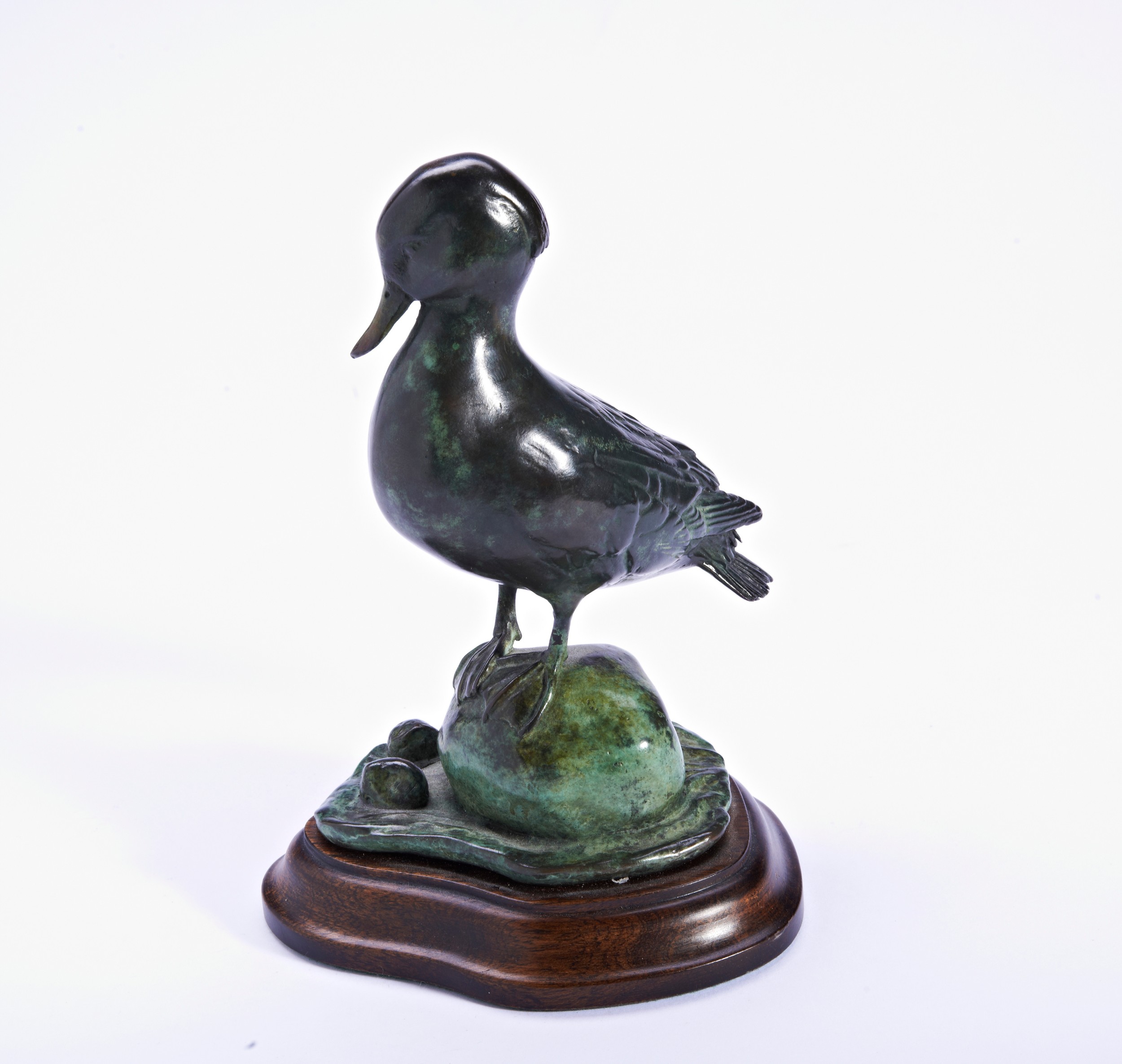 PATRICIA NORTHCROFT, A BRONZE TEAL SCULPTURE, 140/150, on a wooden base. 13.5 cms high.