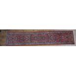 A HAND KNOTTED PERSIAN HALL RUNNER, 20TH CENTURY, decorated with floral sprays within a floral