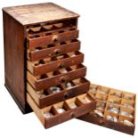 PINE CABINET OF 7 DRAWERS CONTAINING A VERY LARGE QUANTITY OF WATCH GLASSES Height 48cm Width 31cm