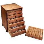 PINE CABINET OF 7 DRAWERS CONTAINING A VERY LARGE QUANTITY OF WATCH GLASSES Height 42cm Width 29cm