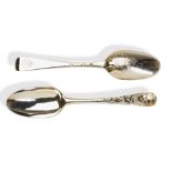 A PAIR OF STAMPED SILVER GILT TABLE SPOONS, LONDON 1725. A pair of table spoons with stamped masks