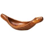 A GOOD CEDARWOOD HAIDA GREASE BOWL in the Form of a Seal carved in stylised elongated flowing form