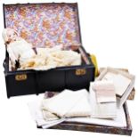 AN EARLY 20TH CENTURY REXINE COVERED DOLLS TRUNK CONTAINING AN ARMAND MARSEILLES 311 BISQUE HEADED