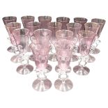 A SET OF 17 VENETIAN CHAMPAGNE FLUTES, 20TH CENTURY, pink tinted tapering bowl on clear glass