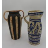 A TWO HANDLED BRONZED STRIPED VASE AND A DUTCH STYLE JUG, the bronzed striped vase with ring