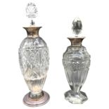 TWO VINTAGE SILVER MOUNTED CUT GLASS DECANTERS, the larger of tapered form with silver mounted