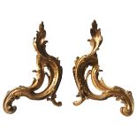 A PAIR OF FRENCH GILT BRASS CHENETS, 19TH CENTURY, scrolling Acanthus leaf form 41 cm high