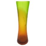 A TALL GREEN AND AMBER SATIN GLASS VASE, CIRCA 1975, tapered waist form, multi faceted brick work