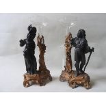 A PAIR OF SPELTER FIGURAL CANDLESTICKS, EARLY 20TH CENTURY, removable etched glass sconces sat