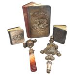 THREE SILVER MOUNTED PRAYER BOOKS AND TWO SILVER BABY RATTLES, each prayer book with silver