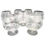 A GROUP OF SEVEN BRANDY GLASSES, 20TH CENTURY, balloon form and ornately etched with a romantic