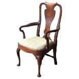 A GEORGE II WALNUT ELBOW CHAIR, CIRCA 1740, curved top rail and vase form splat over a drop-in seat,