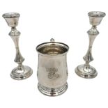 A SILVER TANKARD AND A PAIR OF WEIGHTED SILVER CANDLESTICKS, the wide waisted tankard with