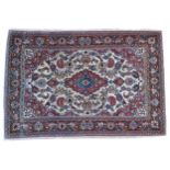 A HAND KNOTTED KASHAN RUG, 20TH CENTURY, central medallion surrounded with a profusion of