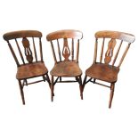 THREE 19TH CENTURY WINDSOR DINING CHAIRS, with pierced vasiform splats above saddle seat panels,