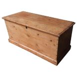 A 19TH CENTURY WAXED PINE STORAGE TRUNK, simplistic rectangular form, on a plinth base 58 x 127 x 55