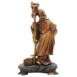A SMALL SOAPSTONE FIGURE OF SHULAO, 20TH CENTURY, modelled in robed attire holding a tree root