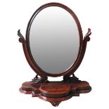 A 19TH CENTURY MAHOGANY TABLE MIRROR, CIRCA 1880, tilting oval plate raised on scrolling supports on