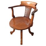 AN EARLY 20TH CENTURY OAK DESK CHAIR, CIRCA 1920, bowed Windsor style top rail above a pierced