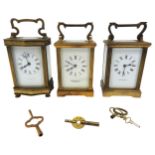 A VINTAGE GARRARD BRASS CARRIAGE CLOCK AND TWO FRENCH CARRIAGE CLOCKS, all with keys 11 cm high max