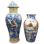 A CHINESE FAMILLE ROSE COVERED BALUSTER VASE, LATE QING DYNASTY, the sides decorated with peacocks