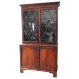 A GEORGE III MAHOGANY BRACKET FOOT BOOKCASE CUPBOARD, CIRCA 1820, in two sections, the top section