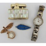 AN AVIA FOB WATCH, AN ENAMELLED SILVER BROOCH AND A RONSON LIGHTER, the watch suspended from a