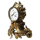 A ORNATE FRENCH BRASS MANTEL CLOCK, LATE 19TH CENTURY, the gilt brass cased surmounted by musical
