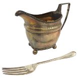 A SILVER CREAMER AND FORK, the boat form creamer with bright cut decoration, raised on bun feet,