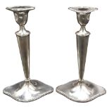 A PAIR OF ELEGANT SILVER CANDLESTICKS, lozenge form weighted bases with tapering columns and