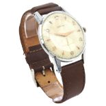 A GENT'S VINTAGE ZENITH WRISTWATCH, stainless steel case on a tan leather strap, the champagne