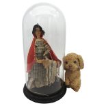 A PEDDLAR DOLL UNDER A GLASS DOME AND A VINTAGE PLUSH DOG WITH A BARKING ACTION.