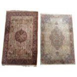 TWO PERSIAN TABRIZ RUGS, 20TH CENTURY, both machine woven with central medallion motifs and deep